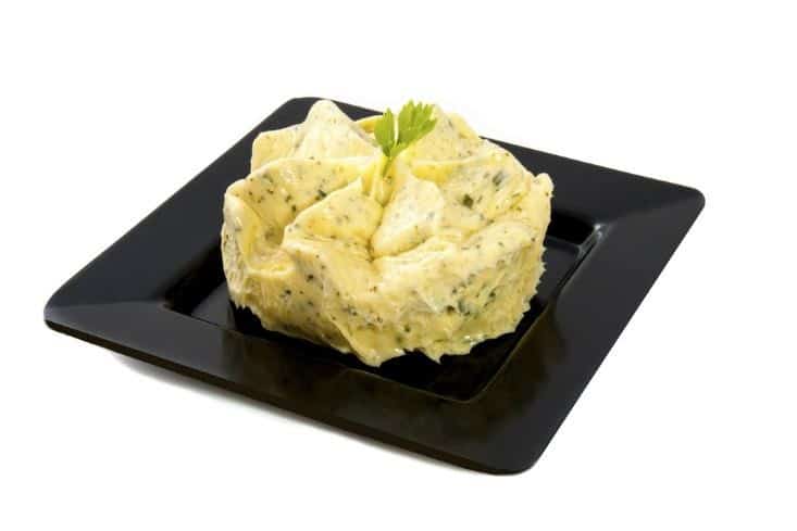 Garlic butter on a black plate